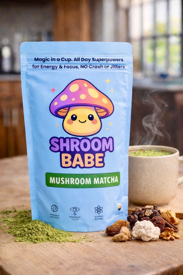 Vibrant green ShroomBabe mushroom matcha whisked in a glass cup.